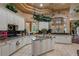 Island kitchen with granite countertops and white cabinets at 531 Isleworth Close, Tarpon Springs, FL 34688