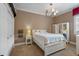 Bright bedroom with white furniture and chandelier at 531 Isleworth Close, Tarpon Springs, FL 34688