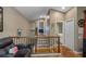 Upstairs hallway with staircase and views into other rooms at 531 Isleworth Close, Tarpon Springs, FL 34688