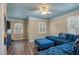 Relaxing bedroom with blue seating area and wood-look floors at 531 Isleworth Close, Tarpon Springs, FL 34688