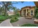 Landscaped front yard with fountain and walkway at 531 Isleworth Close, Tarpon Springs, FL 34688