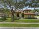 Two-story house with tile roof and landscaping at 531 Isleworth Close, Tarpon Springs, FL 34688