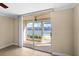 Spacious living area with sliding glass doors opening to a lanai with a serene view of the water at 7625 Sun Island S Dr # 101, South Pasadena, FL 33707