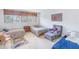 Spacious bedroom featuring two twin beds, a rocking chair, and ample natural light at 838 Monterey Ne Blvd, St Petersburg, FL 33704