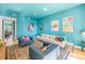 Spacious living area with teal walls, comfortable seating, and views to another room at 838 Monterey Ne Blvd, St Petersburg, FL 33704