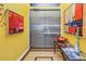 Stylish entryway with yellow walls, metallic double doors, and artwork at 838 Monterey Ne Blvd, St Petersburg, FL 33704