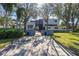 Modern home with a long driveway and lush landscaping, showcasing its architectural design at 838 Monterey Ne Blvd, St Petersburg, FL 33704