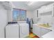 Clean laundry room with washer, dryer, and ample counter space at 838 Monterey Ne Blvd, St Petersburg, FL 33704