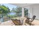 Private balcony with wicker chairs, glass table, and scenic water views at 838 Monterey Ne Blvd, St Petersburg, FL 33704