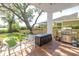 Patio with seating and grill, overlooking backyard and water at 838 Monterey Ne Blvd, St Petersburg, FL 33704