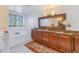 Double vanity bathroom with granite countertops and soaking tub at 838 Monterey Ne Blvd, St Petersburg, FL 33704