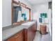 Modern bathroom with a white sink, wood cabinets, and mosaic tile at 838 Monterey Ne Blvd, St Petersburg, FL 33704