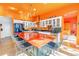 Modern kitchen with orange walls, stainless steel appliances, and an island at 838 Monterey Ne Blvd, St Petersburg, FL 33704