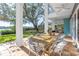 Large covered patio overlooking backyard, featuring a dining table and chairs at 838 Monterey Ne Blvd, St Petersburg, FL 33704
