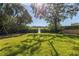 Expansive grassy backyard with mature trees and water view at 838 Monterey Ne Blvd, St Petersburg, FL 33704