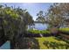 Landscaped backyard with lush greenery, providing privacy and waterfront views at 838 Monterey Ne Blvd, St Petersburg, FL 33704