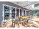 Covered patio with large glass doors, dining table and chairs, and serene water views at 838 Monterey Ne Blvd, St Petersburg, FL 33704