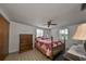 Bedroom with wooden furniture and ceiling fan at 12631 Hobson Simmons Rd, Lithia, FL 33547