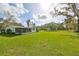 Spacious backyard with a home, shed and wooden fence at 12631 Hobson Simmons Rd, Lithia, FL 33547