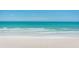 Tranquil beach scene with soft sand and clear ocean water at 16500 Gulf Blvd # 352, North Redington Beach, FL 33708