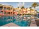 Resort-style pool with reflecting building and palm trees at 16500 Gulf Blvd # 352, North Redington Beach, FL 33708