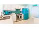 Bright kitchen features teal appliances and mosaic backsplash at 16500 Gulf Blvd # 352, North Redington Beach, FL 33708