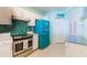 Stylish kitchen featuring teal appliances and white cabinets at 16500 Gulf Blvd # 352, North Redington Beach, FL 33708