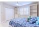 Bright bedroom with built-in shelves and a comfortable bed at 16500 Gulf Blvd # 352, North Redington Beach, FL 33708