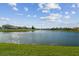 Scenic view of a lake with houses in the background at 1820 Raven Glen Dr, Ruskin, FL 33570