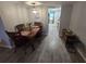 Dining area with wood table and chairs, leading to the kitchen at 1950 59Th N Ave # 214, St Petersburg, FL 33714