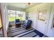 Cozy screened porch with blue striped rug and seating at 209 Palm Ln, Brooksville, FL 34601