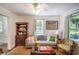 Living area with gray couch and wood shelving unit at 209 Palm Ln, Brooksville, FL 34601