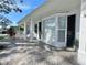 White brick home featuring a covered porch, and elegant bay window, with stone walkway at 2353 Kilgore Dr, Largo, FL 33770