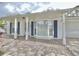 Inviting white brick home featuring a covered porch and elegant bay window with stone walkway at 2353 Kilgore Dr, Largo, FL 33770