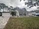 Well-maintained one-story house with a green lawn and a fenced front yard at 2353 Kilgore Dr, Largo, FL 33770