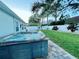 Backyard features a modern hot tub, green lawn, and privacy fence at 2353 Kilgore Dr, Largo, FL 33770