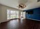 Spacious living room with bay window, wood floors, and blue accent wall at 2353 Kilgore Dr, Largo, FL 33770