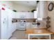 White kitchen with ample counter space, stainless steel appliances, and a breakfast bar at 24617 Laurel Ridge Dr, Lutz, FL 33559