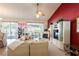 Bright living room with vaulted ceilings, a fireplace, and access to the patio at 24617 Laurel Ridge Dr, Lutz, FL 33559