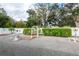 Landscaped backyard with gravel ground cover, white fence, and decorative accents at 24617 Laurel Ridge Dr, Lutz, FL 33559
