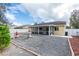 Spacious backyard with screened patio, gravel, and mature trees at 24617 Laurel Ridge Dr, Lutz, FL 33559
