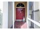 Inviting entryway with a red double door and a terracotta tile floor at 24617 Laurel Ridge Dr, Lutz, FL 33559