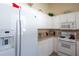White kitchen with stainless steel appliances and ample counter space at 24617 Laurel Ridge Dr, Lutz, FL 33559