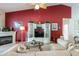 Living room features a red accent wall, fireplace, and built-in entertainment center at 24617 Laurel Ridge Dr, Lutz, FL 33559