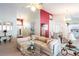Spacious living area with a neutral color palette, comfy seating and a large picture window at 24617 Laurel Ridge Dr, Lutz, FL 33559