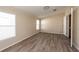 Bright bedroom featuring vinyl flooring and large window at 38029 Leondias Dr, Zephyrhills, FL 33542