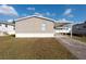 Tan mobile home with carport and paved driveway at 38029 Leondias Dr, Zephyrhills, FL 33542