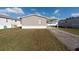 Tan single wide mobile home with carport at 38029 Leondias Dr, Zephyrhills, FL 33542