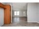 Open living room with vinyl flooring and neutral walls at 38029 Leondias Dr, Zephyrhills, FL 33542