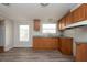 Efficient kitchen featuring wood cabinets and vinyl flooring at 38029 Leondias Dr, Zephyrhills, FL 33542